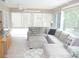 Bright living room with comfortable seating and large windows providing a view of the outdoors at 8377 Se 177Th Bartram Loop, The Villages, FL 32162