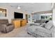 Bright living room with comfortable seating, tile flooring, and sliding glass doors to outdoor space at 8377 Se 177Th Bartram Loop, The Villages, FL 32162