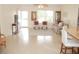 Cozy living room with a comfortable seating arrangement and a well-lit entryway at 8377 Se 177Th Bartram Loop, The Villages, FL 32162