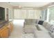 Comfortable living room with plush sectional seating and backyard views, complemented by built-in cabinets at 8377 Se 177Th Bartram Loop, The Villages, FL 32162