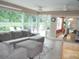 Comfortable living room with large windows and access to outdoor patio and dining areas at 8377 Se 177Th Bartram Loop, The Villages, FL 32162