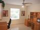 Bright office space with a ceiling fan, large window and built-in desk and shelving at 8377 Se 177Th Bartram Loop, The Villages, FL 32162