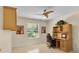 Bright home office with wooden built-in desk, a comfortable chair, and natural light from the window at 8377 Se 177Th Bartram Loop, The Villages, FL 32162