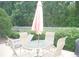 Relaxing outdoor patio with dining set and lounge chairs for enjoying the backyard at 8377 Se 177Th Bartram Loop, The Villages, FL 32162