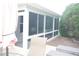 Screened-in porch offers a versatile space for relaxation and enjoying the outdoors bug-free at 8377 Se 177Th Bartram Loop, The Villages, FL 32162