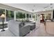 View of the sunroom featuring tiled floor, modern ceiling fans, and large wrap around windows at 8377 Se 177Th Bartram Loop, The Villages, FL 32162