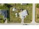 Birds-eye view of a property featuring a pool, decorative driveway, a shed, and a well-maintained lawn at 8850 Se 156Th St, Summerfield, FL 34491