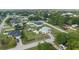 Aerial view of a home with an in-ground pool, shed, well-kept lawn, decorative driveway and a convenient location at 8850 Se 156Th St, Summerfield, FL 34491