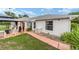 View of the home's rear facade with a patio and walkway at 8850 Se 156Th St, Summerfield, FL 34491