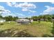 An expansive backyard featuring a pool and sheds at 8850 Se 156Th St, Summerfield, FL 34491