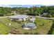 Backyard showing home's pool, gazebo, storage sheds, and well maintained lawn at 8850 Se 156Th St, Summerfield, FL 34491