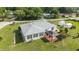 Backyard featuring a gazebo, flower garden, and well-maintained lawn at 8850 Se 156Th St, Summerfield, FL 34491