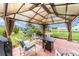 Cozy backyard patio with comfortable seating, and a pergola for relaxing outdoor experience at 8850 Se 156Th St, Summerfield, FL 34491