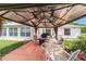 Backyard patio with comfortable seating, grill, and a gazebo, perfect for outdoor relaxation at 8850 Se 156Th St, Summerfield, FL 34491