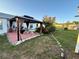 Charming backyard patio with covered gazebo and barbecue, surrounded by garden at 8850 Se 156Th St, Summerfield, FL 34491