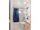 Well-lit bathroom with tiled walls, a shower-tub combo, and white fixtures at 8850 Se 156Th St, Summerfield, FL 34491