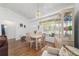 Charming dining area with chandelier, wood floors, and a bright window at 8850 Se 156Th St, Summerfield, FL 34491