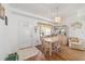 Cozy dining room featuring wood floors, a decorative chandelier, and a curio cabinet at 8850 Se 156Th St, Summerfield, FL 34491