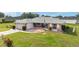 Charming single-story home with a cozy screened-in porch, a manicured lawn, and a decorative driveway at 8850 Se 156Th St, Summerfield, FL 34491
