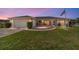 Charming single-story home featuring a well-manicured lawn, a two-car garage, and a welcoming screened-in porch at 8850 Se 156Th St, Summerfield, FL 34491