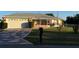 Lovely home featuring an attached garage, front screened-in porch, and a classic mailbox at 8850 Se 156Th St, Summerfield, FL 34491