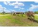 Well-maintained home with a spacious front yard, mature landscaping, and cozy porch at 8850 Se 156Th St, Summerfield, FL 34491