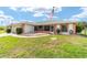 Single Gathering home featuring a screened in patio, colorful painted exterior, manicured lawn and mature landscaping at 8850 Se 156Th St, Summerfield, FL 34491