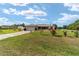 Inviting home with a well-kept lawn, colorful landscaping and large driveway at 8850 Se 156Th St, Summerfield, FL 34491
