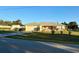 Well-maintained home with an attached garage, a quaint screened porch, and a beautifully landscaped front yard at 8850 Se 156Th St, Summerfield, FL 34491
