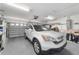 Spacious garage featuring a modern car and ample storage at 8850 Se 156Th St, Summerfield, FL 34491