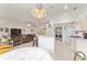 Open kitchen layout with an island, adjacent laundry area, and views of the living room at 8850 Se 156Th St, Summerfield, FL 34491
