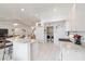 Well-lit kitchen with white appliances, an island with bar seating, and a convenient laundry area at 8850 Se 156Th St, Summerfield, FL 34491