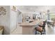 Bright kitchen with a breakfast bar, white appliances, and adjacent dining area at 8850 Se 156Th St, Summerfield, FL 34491
