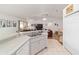 Bright kitchen view showcasing the sink, white cabinets and flowing into the living and dining area at 8850 Se 156Th St, Summerfield, FL 34491