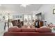 Bright living room with a ceiling fan, hardwood floors, and sliding glass doors to the backyard at 8850 Se 156Th St, Summerfield, FL 34491