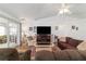 Comfortable living room featuring neutral colors, a ceiling fan, and access to an outdoor space at 8850 Se 156Th St, Summerfield, FL 34491
