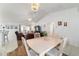 Open concept living and dining area with wood floors and a view of the backyard at 8850 Se 156Th St, Summerfield, FL 34491