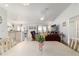 Bright and open living space with hardwood floors, seamlessly connecting the dining area, living room, and kitchen at 8850 Se 156Th St, Summerfield, FL 34491