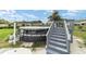 View of the above-ground pool with steps leading to a deck, partially covered at 8850 Se 156Th St, Summerfield, FL 34491