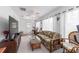Relaxing sunroom with floral sofa, ceiling fan, plenty of light, and access to the back yard at 8850 Se 156Th St, Summerfield, FL 34491