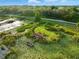 Aerial view of a building and dock with surrounding foliage at 9269 Silver Lake Dr, Leesburg, FL 34788