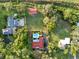Beautiful aerial view of the house and property, featuring lush landscaping and a swimming pool at 9269 Silver Lake Dr, Leesburg, FL 34788