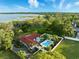 An inviting home featuring a swimming pool, fenced yard, and mature trees, offering a tranquil setting with lake views at 9269 Silver Lake Dr, Leesburg, FL 34788