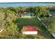 Expansive aerial shot of property featuring a big yard, lake, and a barn at 9269 Silver Lake Dr, Leesburg, FL 34788
