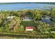 Aerial shot showing house and big yard with a lake in the background surrounded by trees at 9269 Silver Lake Dr, Leesburg, FL 34788