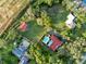 Expansive aerial view of the property showcasing a pool, lush greenery, and multiple structures at 9269 Silver Lake Dr, Leesburg, FL 34788