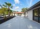 Outdoor patio area with dining table, palm trees, and a view of the property at 9269 Silver Lake Dr, Leesburg, FL 34788