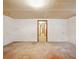 Large unfinished basement with concrete floors, doorway, and potential for various uses at 9269 Silver Lake Dr, Leesburg, FL 34788