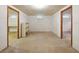 Spacious basement with two doorways and concrete floors, ready for customization at 9269 Silver Lake Dr, Leesburg, FL 34788