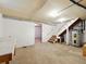 Unfinished basement featuring stairs, water heater, and open space ready to be customized at 9269 Silver Lake Dr, Leesburg, FL 34788